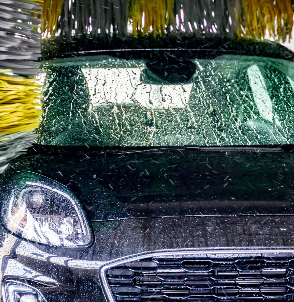 A vehicle in an automatic car wash.