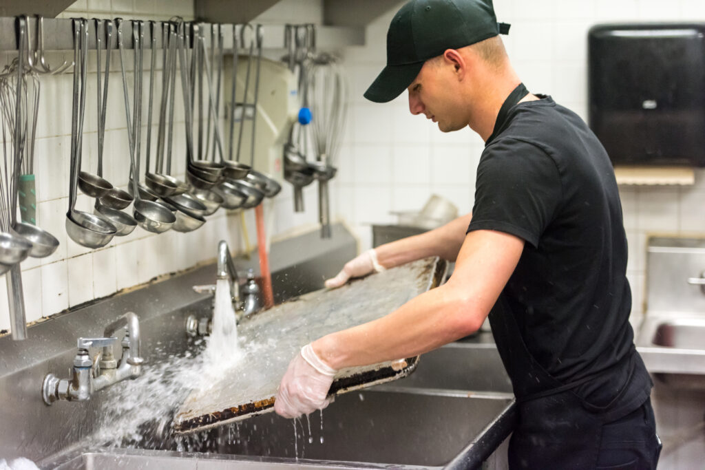 man washing dishes