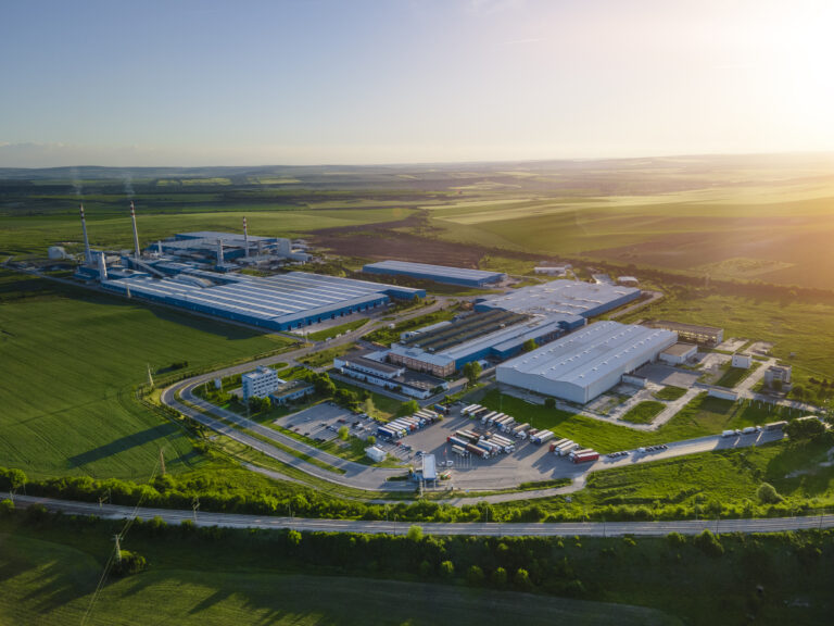 Industry surrounded by green nature, aerial view.